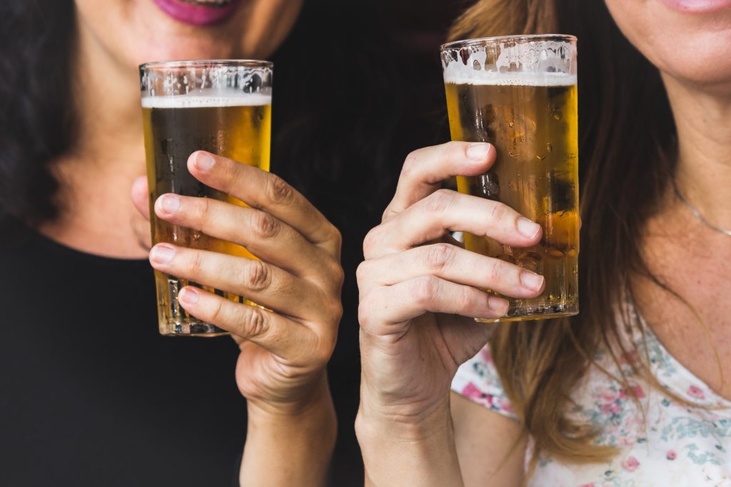 two women holding beer