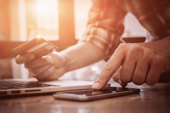 Online payment,Man's hands pointing smartphone and using credit card for online shopping.